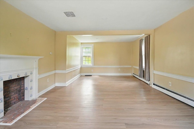 32 Skillings Corner Rd, Auburn, ME 04210 - unfurnished living room featuring a fireplace with raised hearth, light wood-style flooring, baseboards, and baseboard heating
