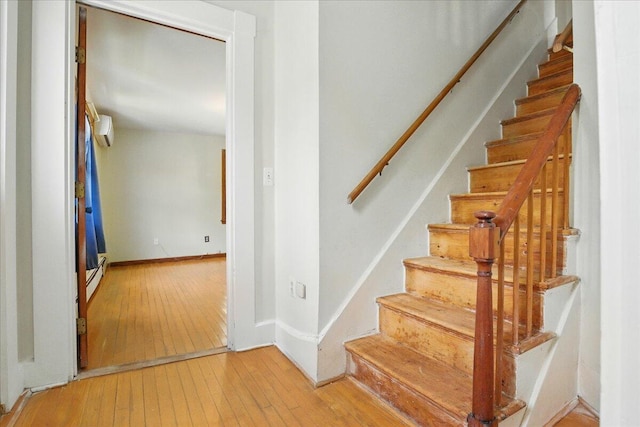 32 Skillings Corner Rd, Auburn, ME 04210 - stairway with wood-type flooring, a wall unit AC, and baseboard heating