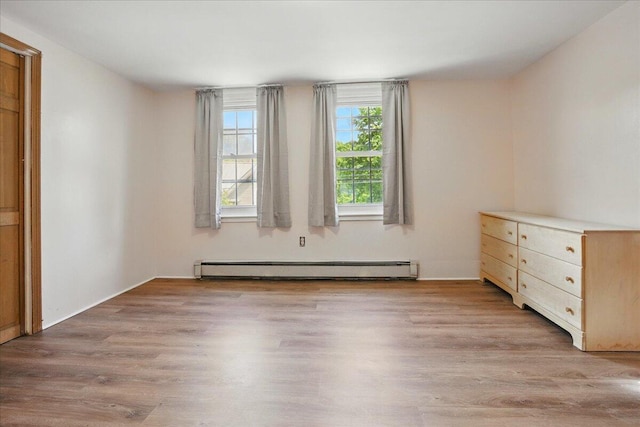 32 Skillings Corner Rd, Auburn, ME 04210 - unfurnished bedroom featuring baseboard heating and light wood-style floors