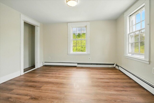 32 Skillings Corner Rd, Auburn, ME 04210 - unfurnished room featuring healthy amount of natural light, wood finished floors, and a baseboard radiator