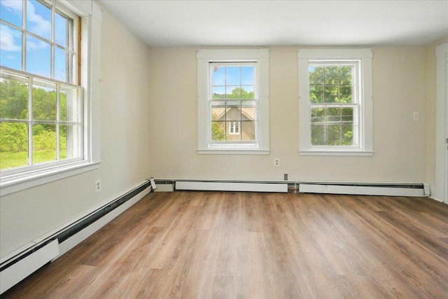 32 Skillings Corner Rd, Auburn, ME 04210 - empty room featuring a baseboard heating unit, wood finished floors, and a baseboard radiator