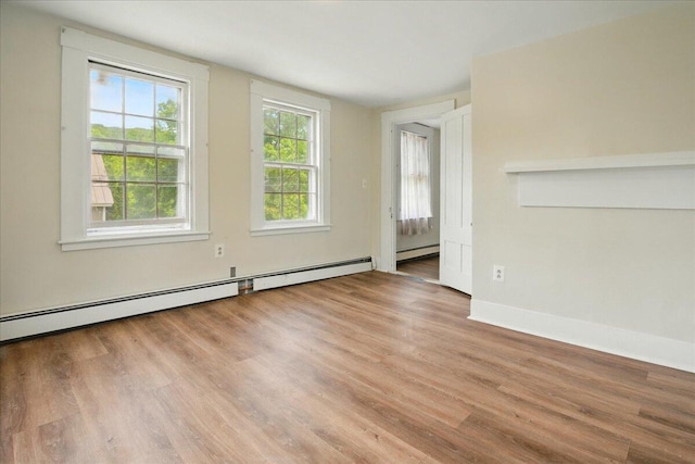 32 Skillings Corner Rd, Auburn, ME 04210 - spare room featuring a baseboard heating unit, wood finished floors, and baseboards