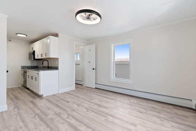 5 Kinney Ave Unit 302, Old Orchard Beach, ME 04064 - kitchen featuring plenty of natural light, crown molding, light wood-style floors, white cabinetry, and a sink