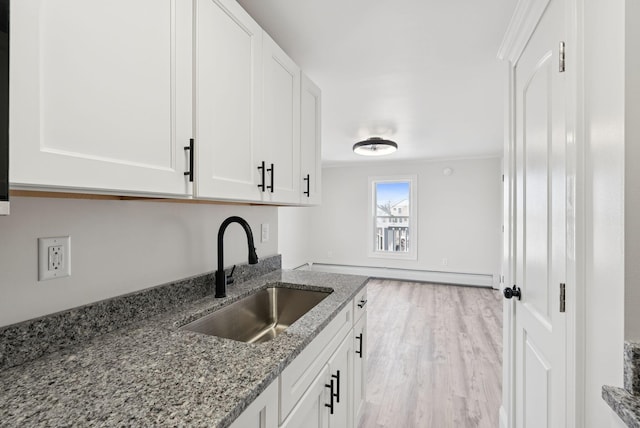 5 Kinney Ave Unit 302, Old Orchard Beach, ME 04064 - kitchen with a sink, stone counters, baseboard heating, white cabinetry, and crown molding