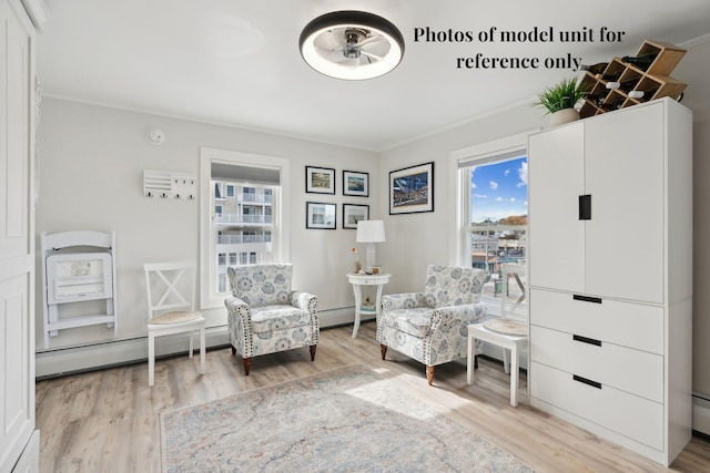 5 Kinney Ave Unit 302, Old Orchard Beach, ME 04064 - living area featuring baseboard heating, ornamental molding, light wood-style floors, and ceiling fan