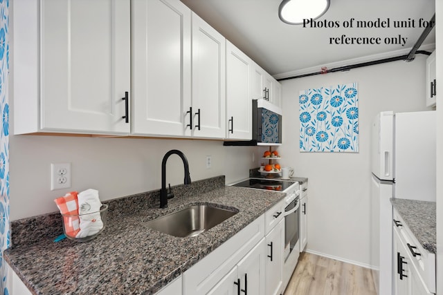 5 Kinney Ave Unit 302, Old Orchard Beach, ME 04064 - kitchen featuring a sink, white appliances, dark stone countertops, and light wood-style floors