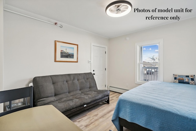 5 Kinney Ave Unit 302, Old Orchard Beach, ME 04064 - bedroom featuring wood finished floors, baseboard heating, and crown molding