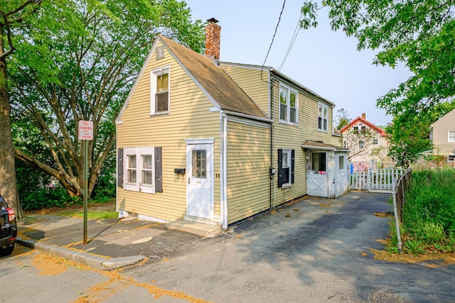 13 Monroe St, Portland, ME 04101 - view of front facade featuring a chimney and roof with shingles