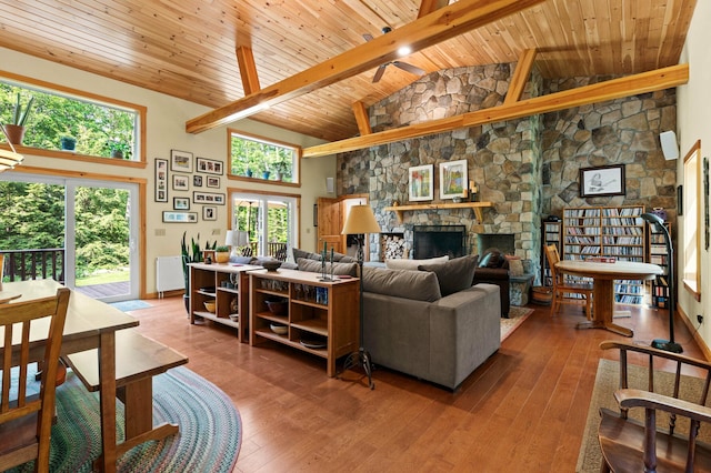 21 Jones Dr, Hartford, ME 04220 - living area featuring high vaulted ceiling, a wood ceiling with exposed beams, hardwood / wood-style flooring, and a stone fireplace