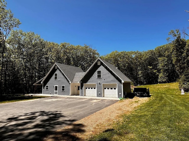 9 Springer Ln, Morrill, ME 04952 - view of front of house featuring driveway, a front lawn, and an attached garage