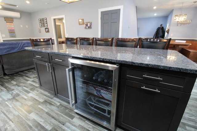 9 Springer Ln, Morrill, ME 04952 - kitchen with beverage cooler, light wood-style floors, open floor plan, stone counters, and a chandelier