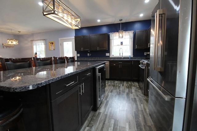 9 Springer Ln, Morrill, ME 04952 - kitchen with stainless steel appliances, beverage cooler, a sink, light wood finished floors, and dark stone countertops