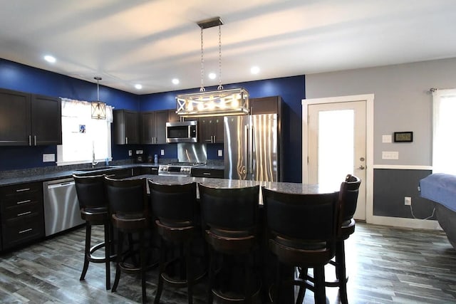 9 Springer Ln, Morrill, ME 04952 - kitchen with appliances with stainless steel finishes, plenty of natural light, dark countertops, a kitchen bar, and recessed lighting