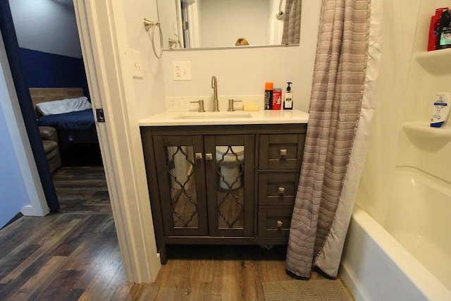 9 Springer Ln, Morrill, ME 04952 - full bathroom featuring vanity, wood finished floors, and shower / bath combo with shower curtain