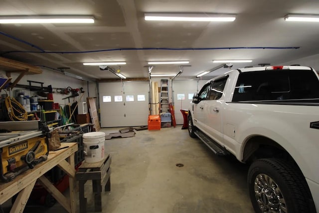 9 Springer Ln, Morrill, ME 04952 - garage featuring a workshop area and a garage door opener