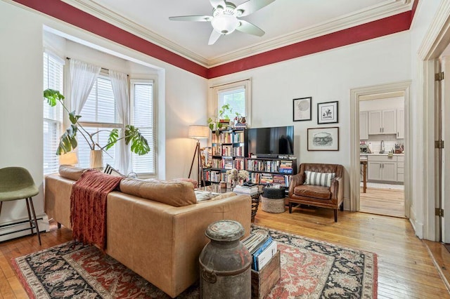 130 Emery St, Portland, ME 04102 - living area with a baseboard heating unit, light wood-style flooring, a ceiling fan, and crown molding