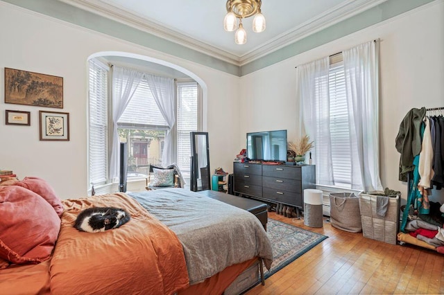130 Emery St, Portland, ME 04102 - bedroom featuring ornamental molding, hardwood / wood-style floors, and arched walkways