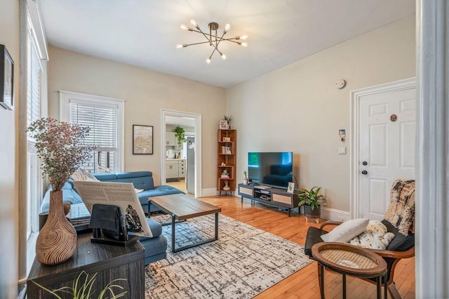 130 Emery St, Portland, ME 04102 - living area with wood finished floors and a chandelier