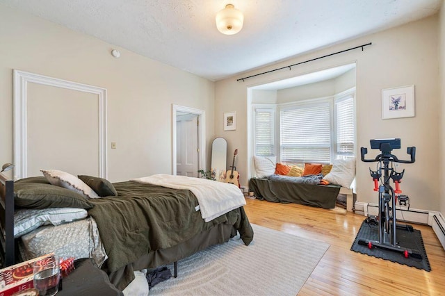 130 Emery St, Portland, ME 04102 - bedroom with wood finished floors and a baseboard radiator