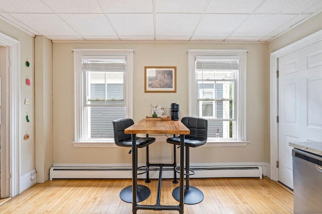 130 Emery St, Portland, ME 04102 - dining space featuring hardwood / wood-style floors, a paneled ceiling, and baseboard heating
