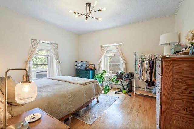 130 Emery St, Portland, ME 04102 - bedroom featuring a chandelier, hardwood / wood-style floors, ornamental molding, and cooling unit
