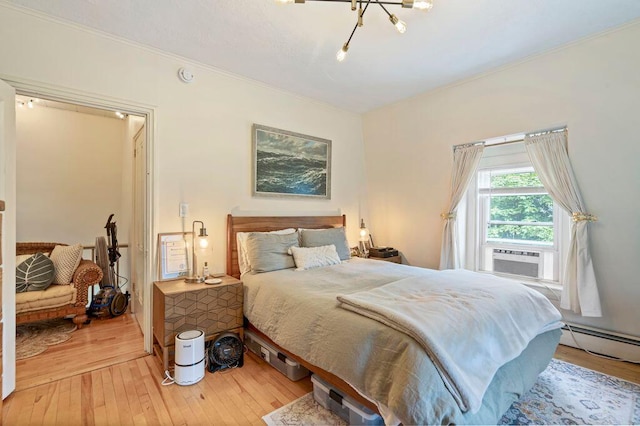 130 Emery St, Portland, ME 04102 - bedroom with cooling unit, light wood-type flooring, crown molding, and a baseboard heating unit