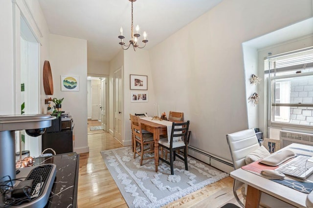 130 Emery St, Portland, ME 04102 - dining space featuring a baseboard radiator, light wood-style flooring, a chandelier, and a wall mounted AC