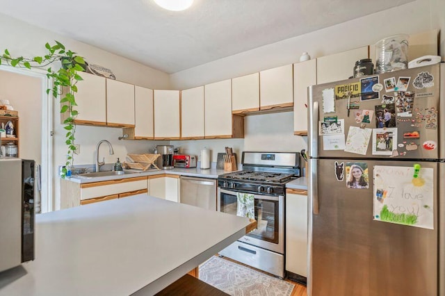 130 Emery St, Portland, ME 04102 - kitchen with stainless steel appliances, light countertops, and white cabinets