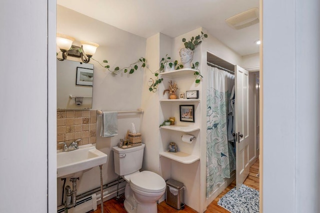130 Emery St, Portland, ME 04102 - full bathroom with wood finished floors, a shower with curtain, and decorative backsplash