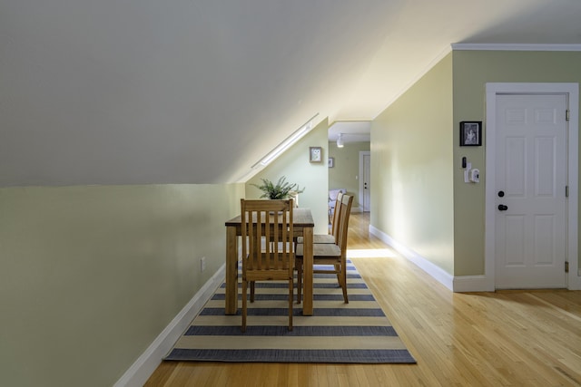 18 Sherman St Unit 4, Portland, ME 04101 - dining room featuring wood finished floors, vaulted ceiling, and ornamental molding