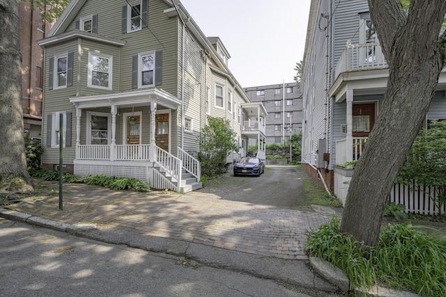 18 Sherman St Unit 4, Portland, ME 04101 - view of front of property featuring a porch and decorative driveway