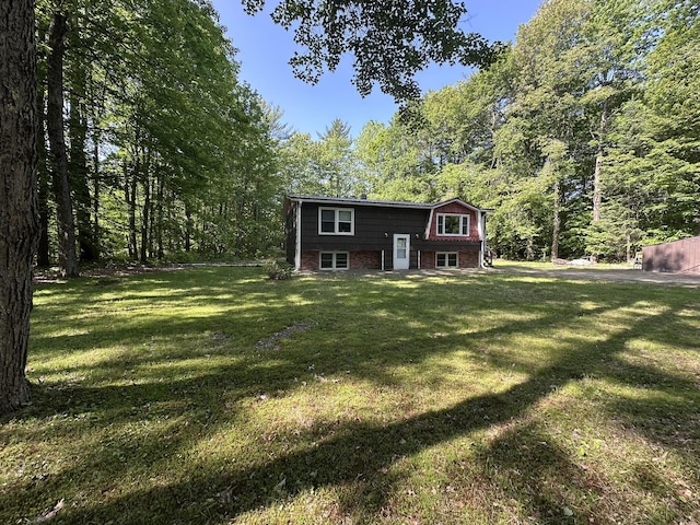15 Balsam Ln, Naples, ME 04055 - back of house featuring a lawn, brick siding, and a view of trees