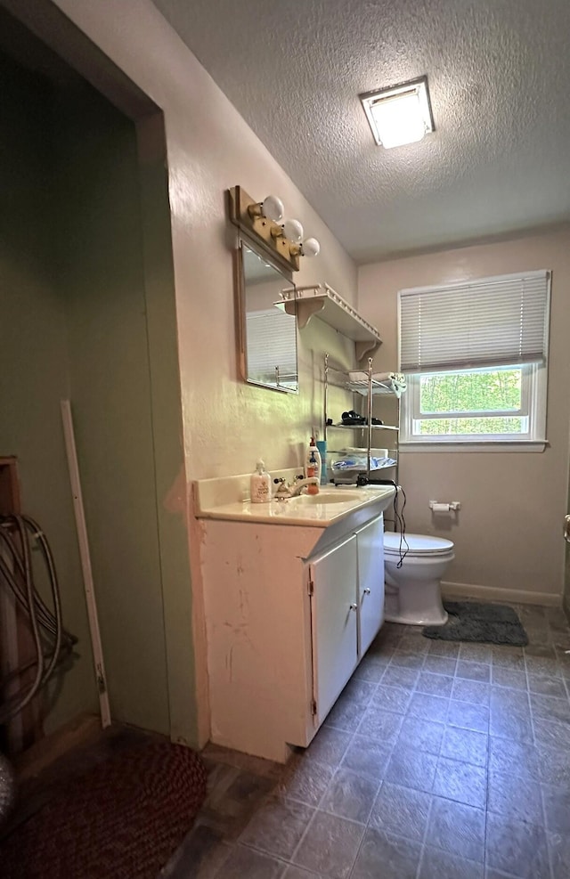 15 Balsam Ln, Naples, ME 04055 - bathroom with vanity, toilet, a textured ceiling, and baseboards