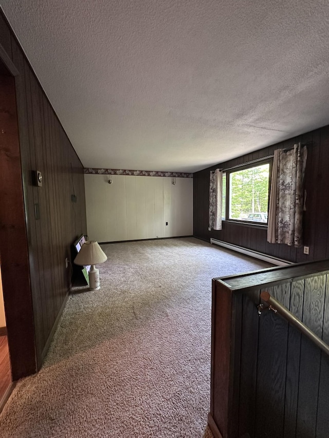 15 Balsam Ln, Naples, ME 04055 - carpeted spare room featuring a baseboard heating unit, wooden walls, and a textured ceiling