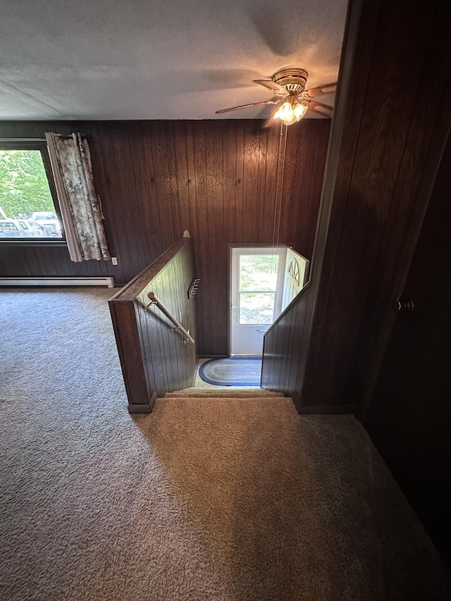 15 Balsam Ln, Naples, ME 04055 - staircase featuring carpet, plenty of natural light, ceiling fan, wooden walls, and baseboard heating
