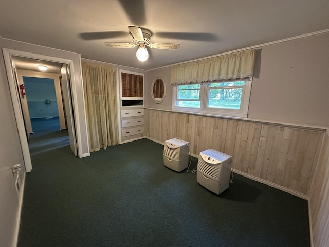 15 Balsam Ln, Naples, ME 04055 - unfurnished bedroom with a wainscoted wall, dark colored carpet, wood walls, and a ceiling fan