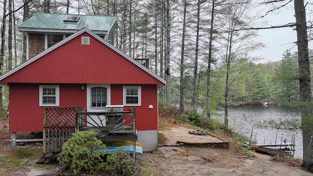 110 Indian Point Dr, Denmark, ME 04022 - rear view of house with a view of trees, a deck with water view, and metal roof