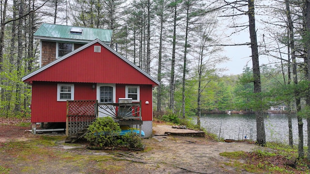 110 Indian Point Dr, Denmark, ME 04022 - view of front facade with a water view, a view of trees, and metal roof