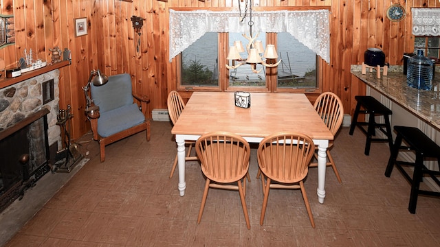 110 Indian Point Dr, Denmark, ME 04022 - dining room featuring baseboard heating, wood walls, a fireplace, and tile patterned floors