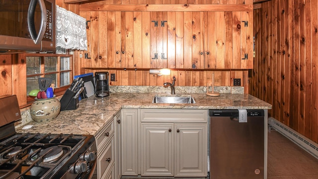 110 Indian Point Dr, Denmark, ME 04022 - kitchen with appliances with stainless steel finishes, a sink, a baseboard radiator, wooden walls, and light stone countertops