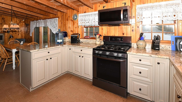 110 Indian Point Dr, Denmark, ME 04022 - kitchen with gas stove, stainless steel microwave, wood walls, beam ceiling, and a peninsula