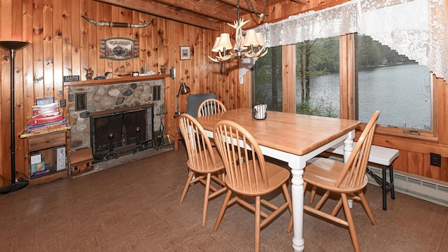 110 Indian Point Dr, Denmark, ME 04022 - dining room featuring wood walls, a chandelier, tile patterned floors, a stone fireplace, and a water view