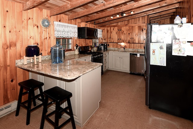 110 Indian Point Dr, Denmark, ME 04022 - kitchen featuring freestanding refrigerator, black microwave, dishwasher, gas range, and a baseboard heating unit