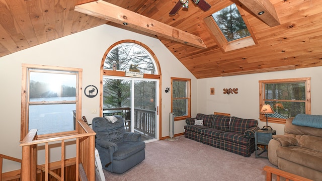 110 Indian Point Dr, Denmark, ME 04022 - carpeted living room featuring wooden ceiling with exposed beams, a skylight, ceiling fan, and high vaulted ceiling