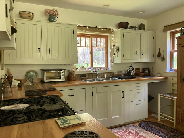 12 Bakers Pt, Steuben, ME 04680 - kitchen with healthy amount of natural light, cooktop, and wood finished floors