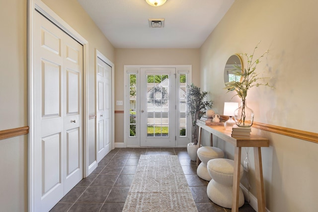 8 Kavanaugh Rd Unit 8, Old Orchard Beach, ME 04064 - entrance foyer with dark tile patterned floors and baseboards