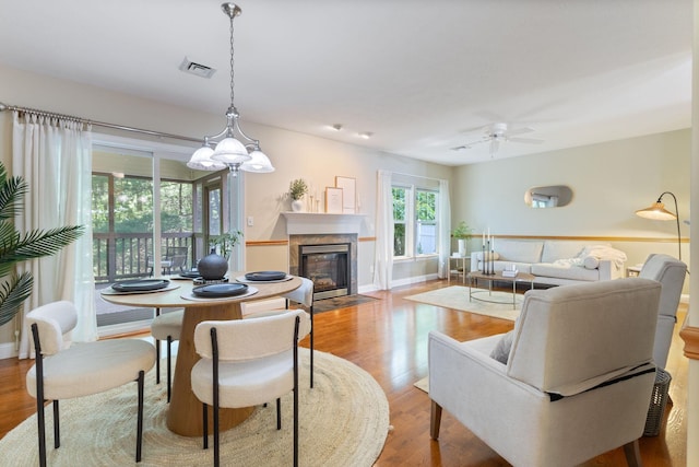 8 Kavanaugh Rd Unit 8, Old Orchard Beach, ME 04064 - living room featuring a ceiling fan, wood finished floors, a fireplace, and a chandelier