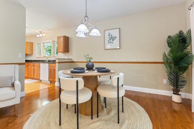 8 Kavanaugh Rd Unit 8, Old Orchard Beach, ME 04064 - dining room with light wood-style flooring and a chandelier