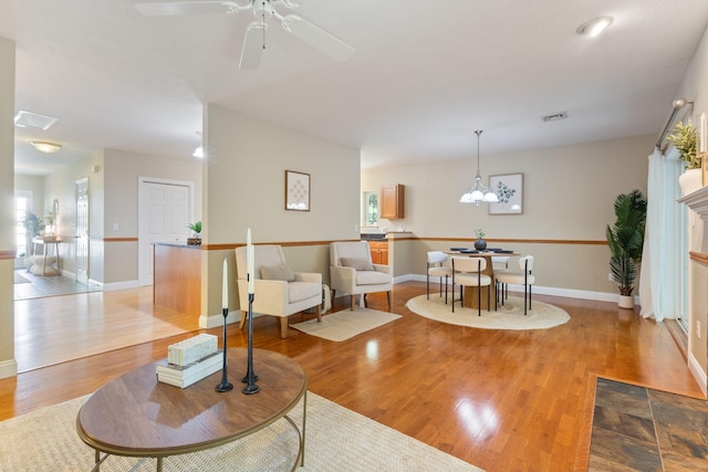 8 Kavanaugh Rd Unit 8, Old Orchard Beach, ME 04064 - living area with light wood-style floors, ceiling fan, and a chandelier