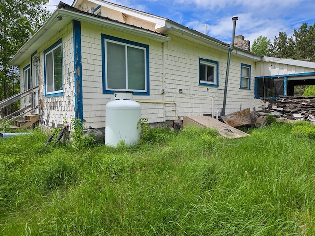 291 Pea Ridge Rd, Chester, ME 04457 - view of home's exterior with a chimney